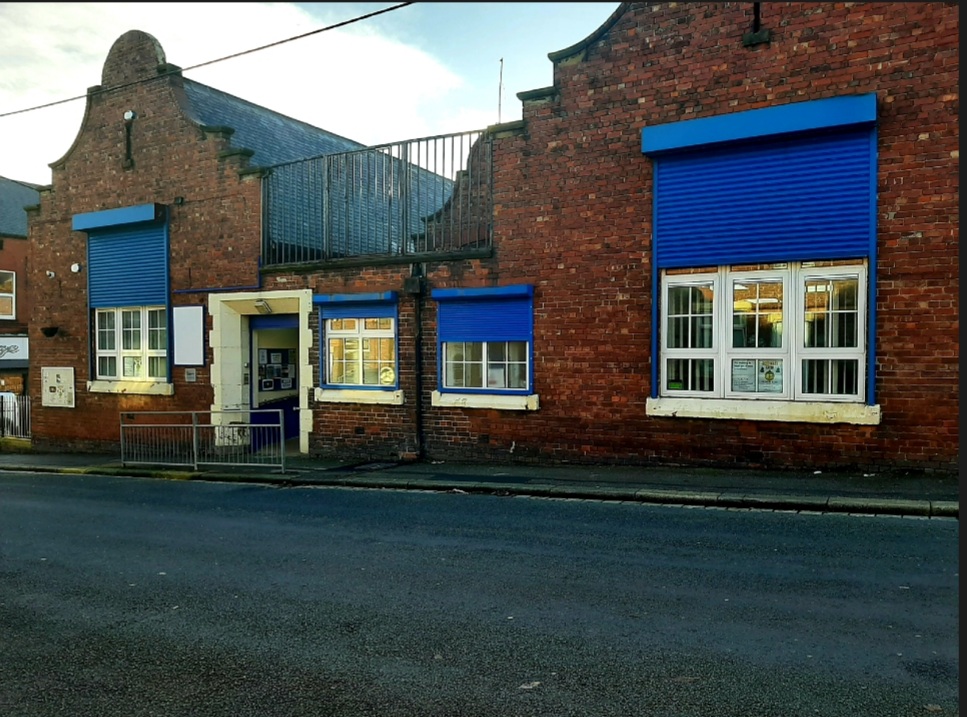 Tina Philips Training Room, brick building with blue shutters, ideal for community events.