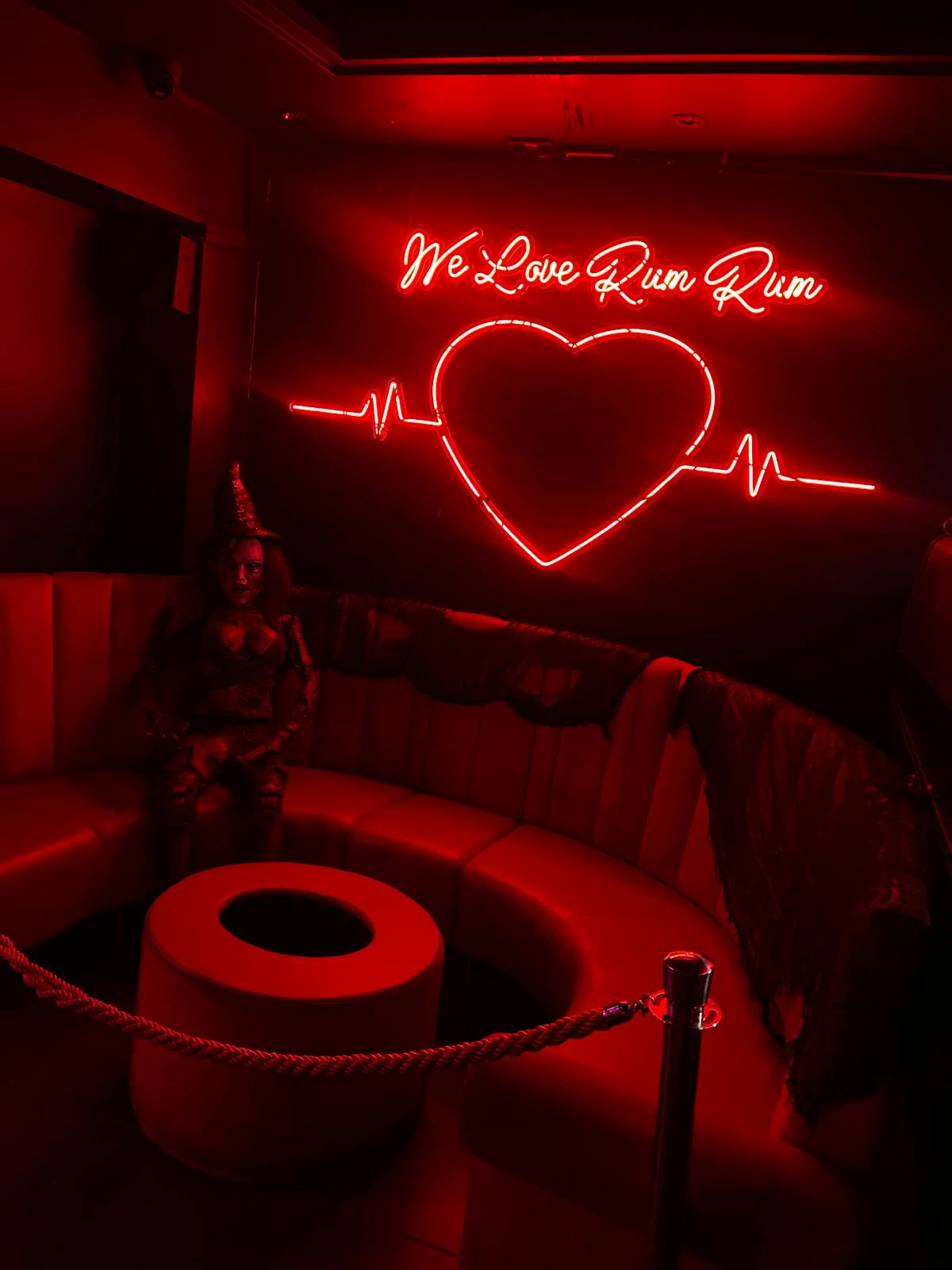 Vibrant Rum Rum Bar lounge with red lighting, perfect for intimate events and gatherings.