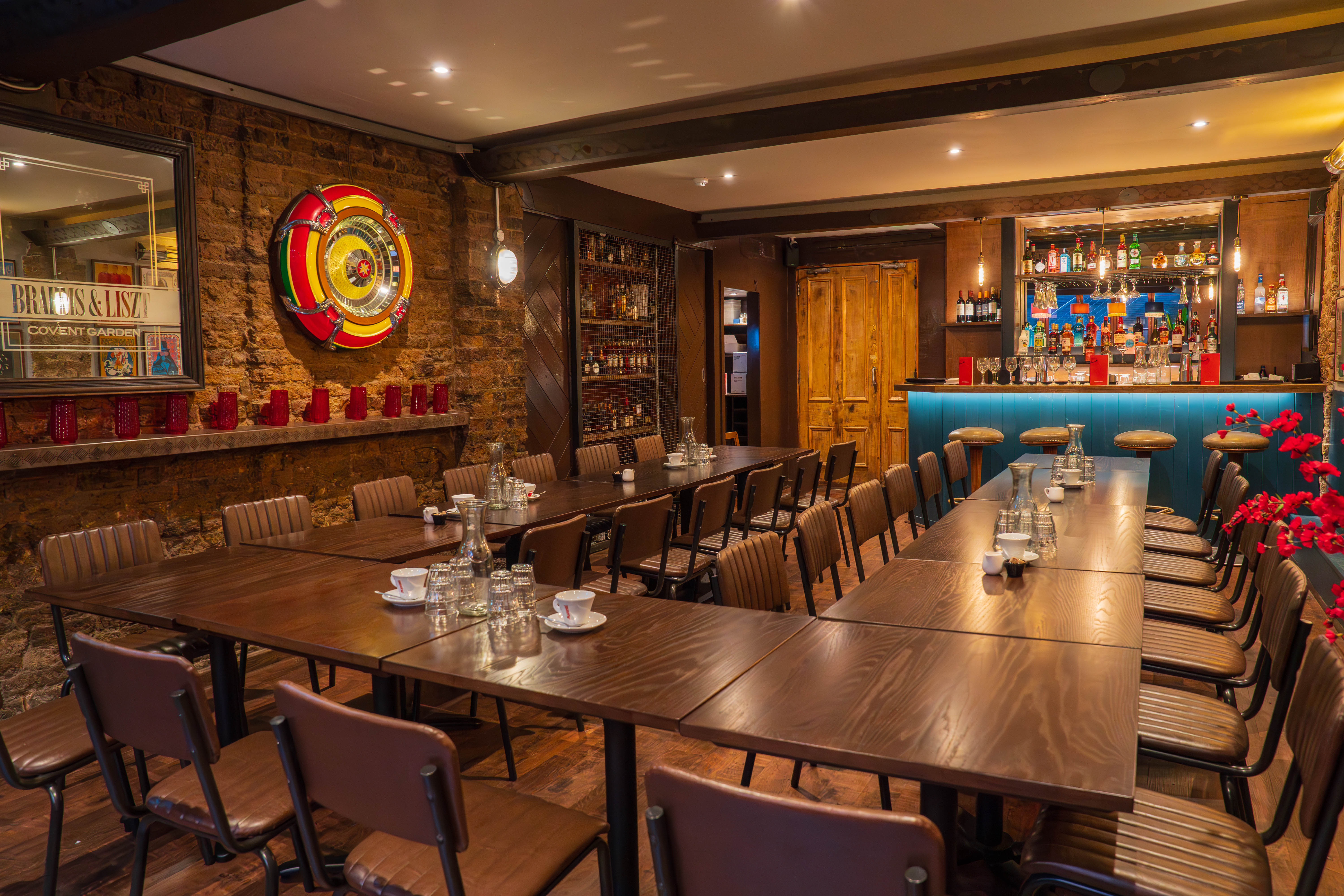 Modern meeting space at Maxwell's Bar with wooden table, perfect for workshops and gatherings.