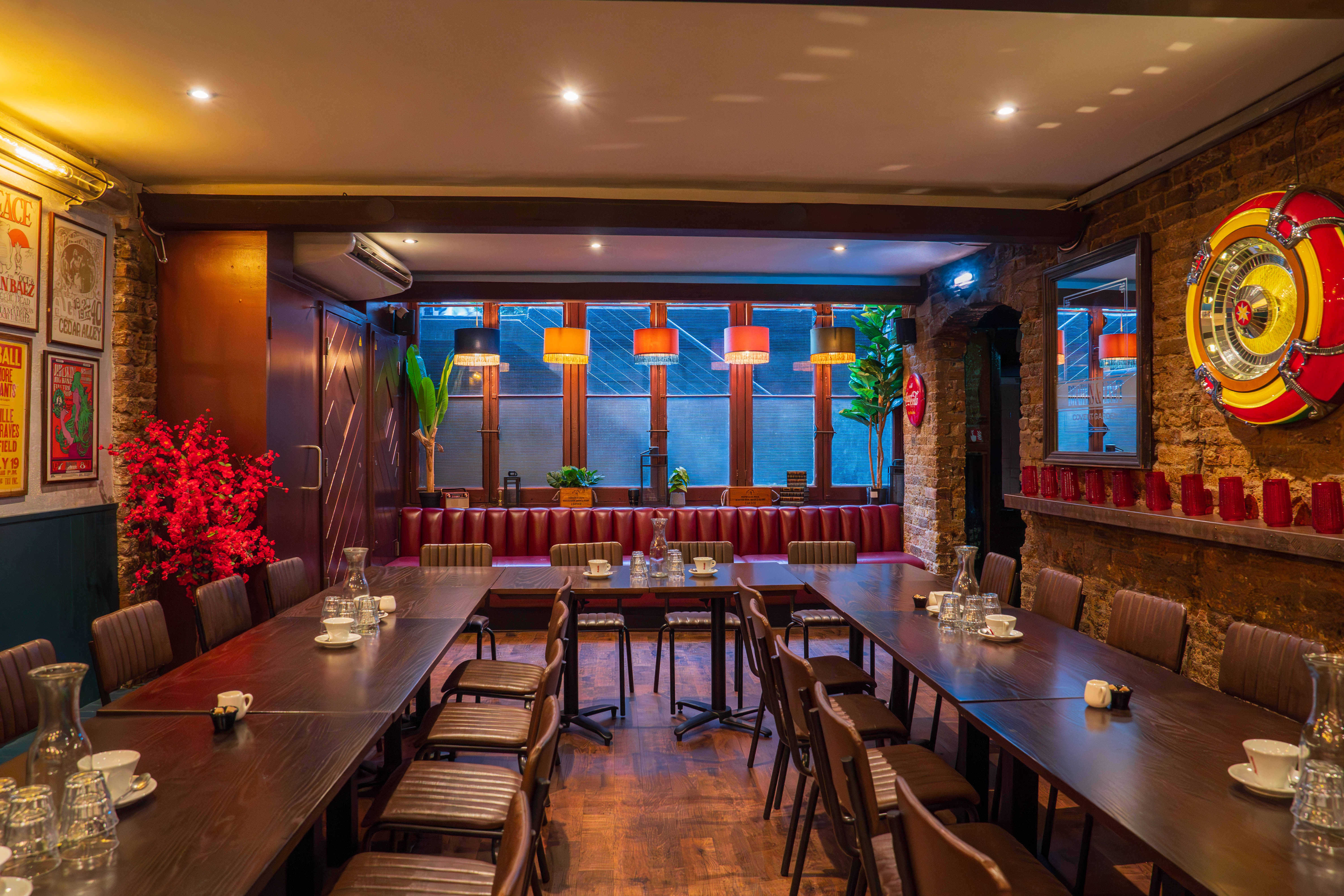 Intimate meeting space at Maxwell's Bar with U-shaped wooden tables for workshops.