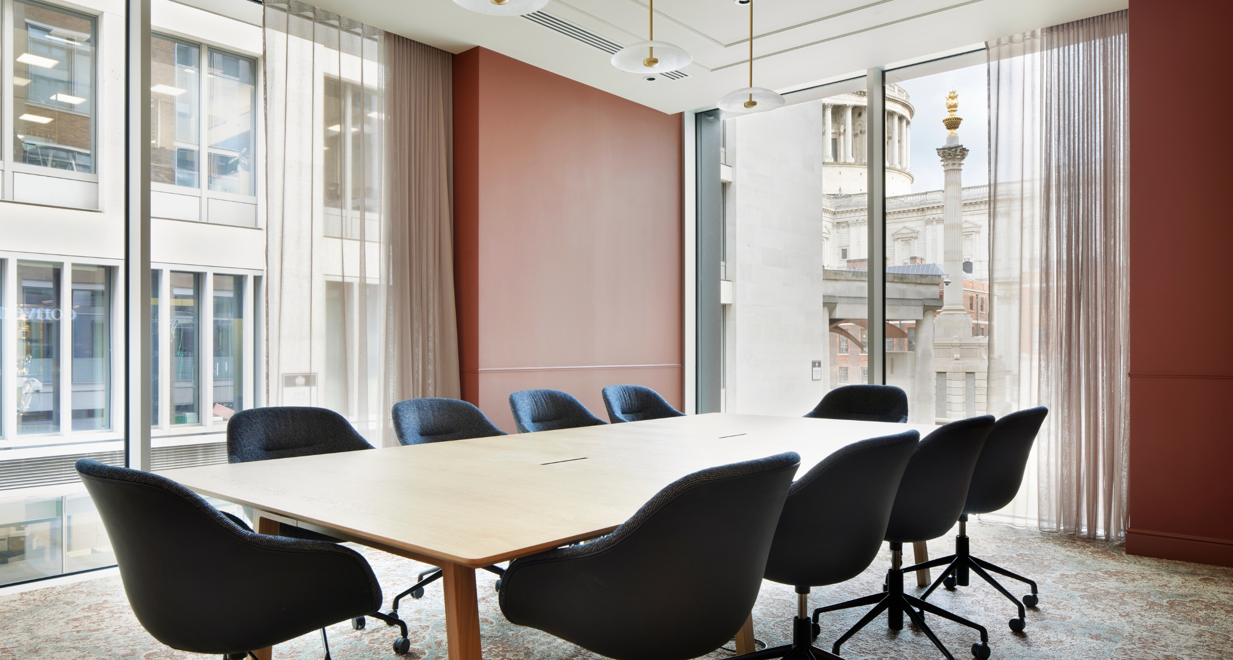 Modern conference room with large wooden table, ideal for productive meetings and events.