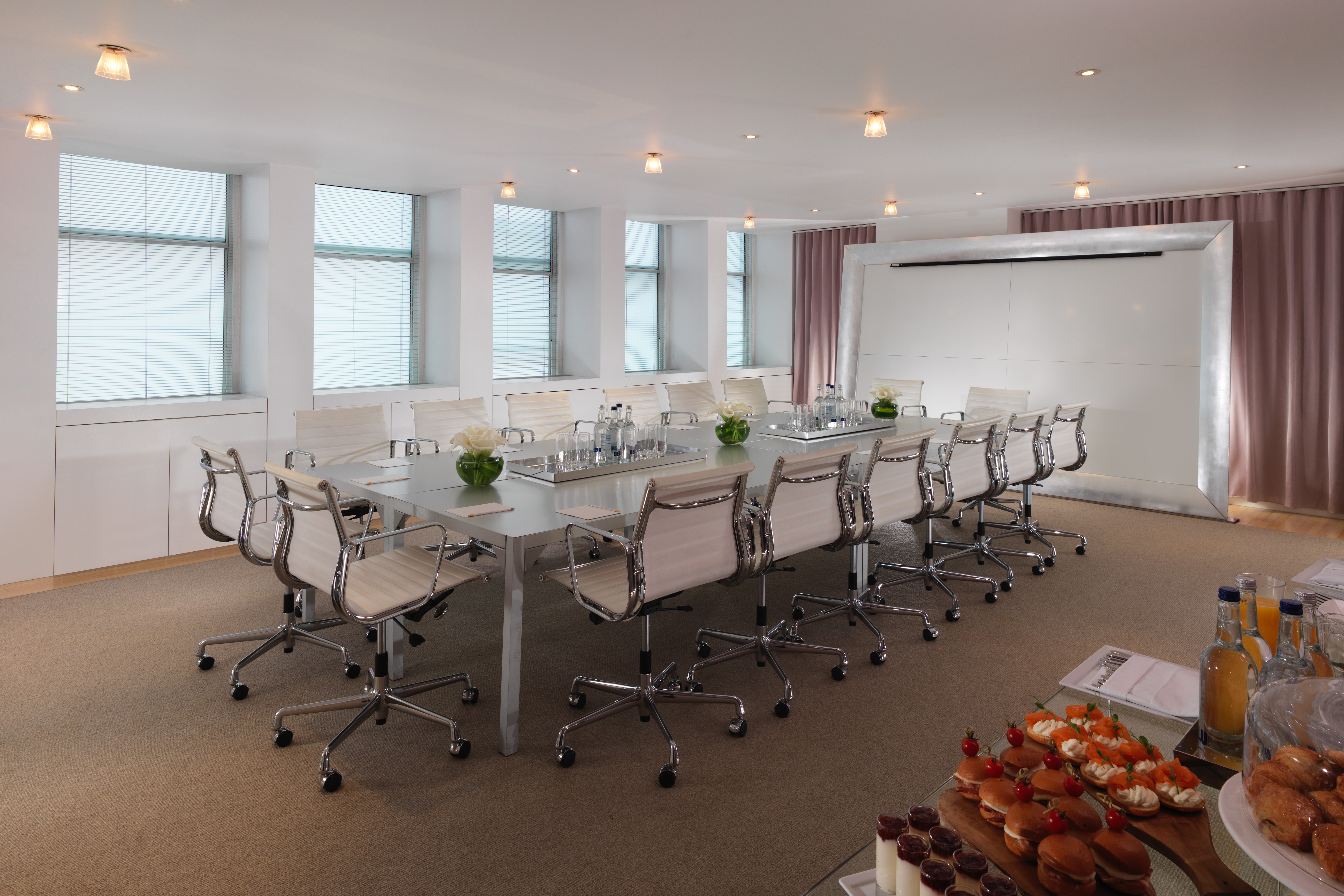 Modern boardroom in Sanderson London, featuring a sleek table for corporate meetings.