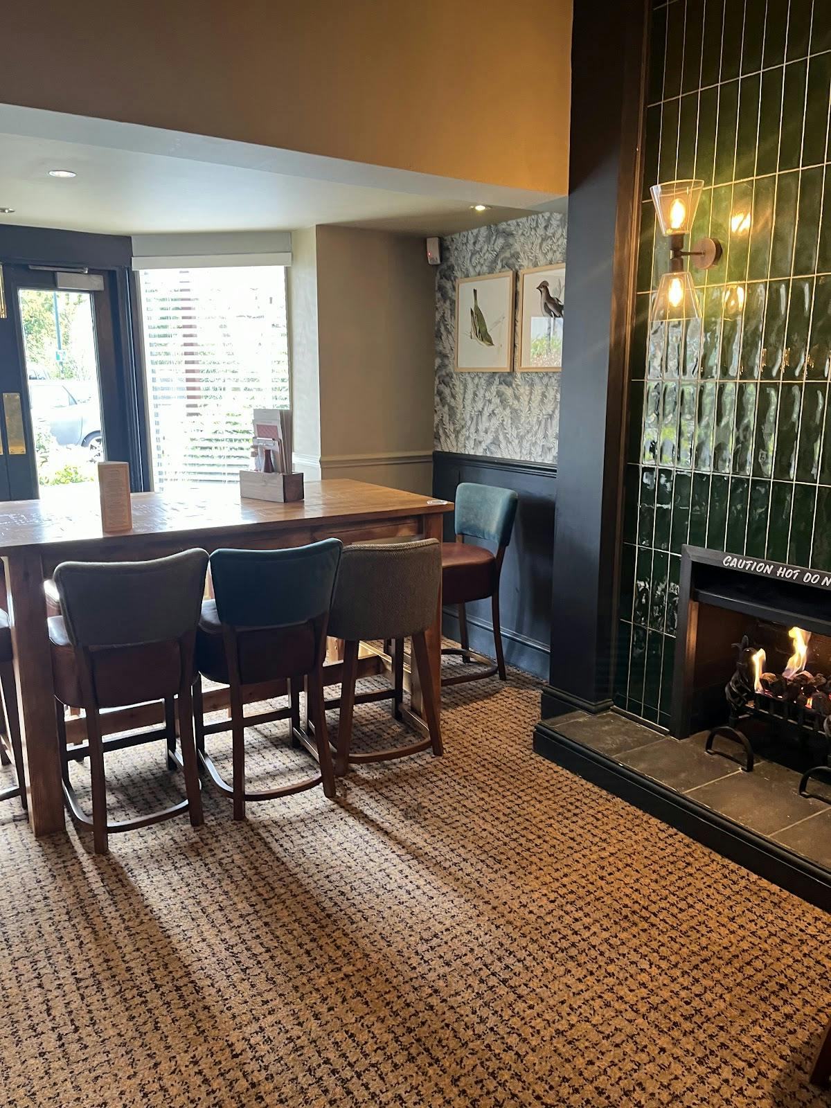 Cozy gastropub meeting space with wooden table, ideal for small events and gatherings.