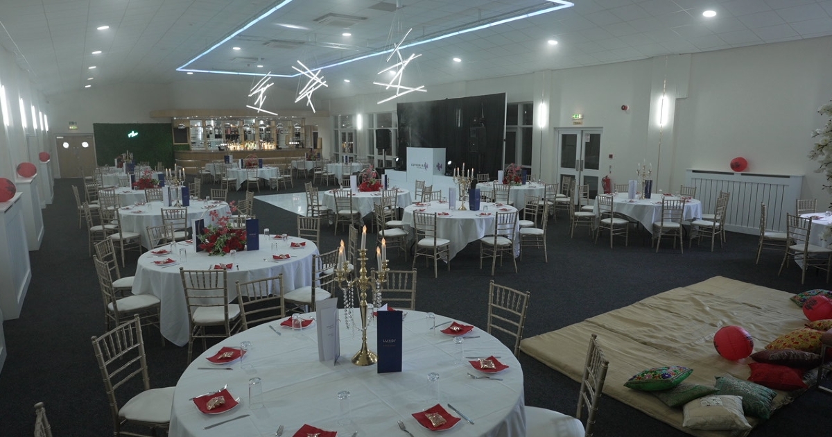 Elegant event hall with round tables, ideal for corporate gatherings and celebrations.