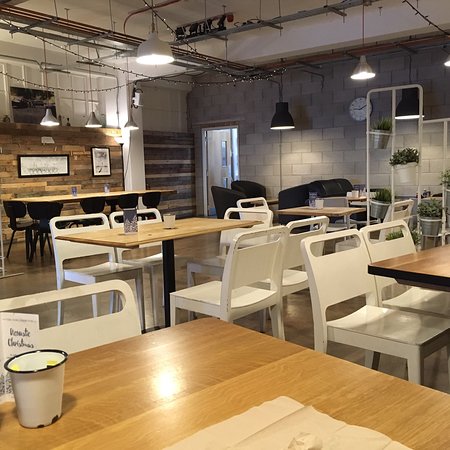 Modern dining space at OIKOS Café, perfect for casual meetings and events.