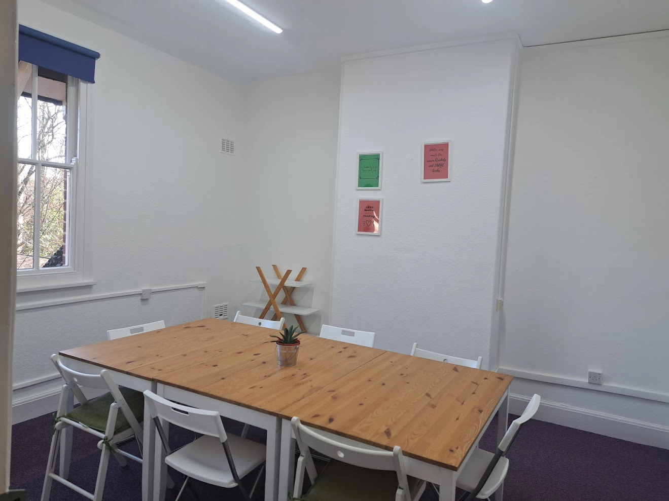 Bright Sycamore Room with wooden table, ideal for meetings and workshops.