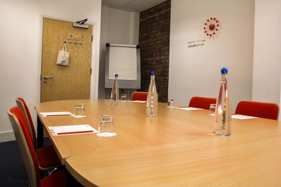 Sycamore Room at The Hub: modern meeting space with round table for productive events.