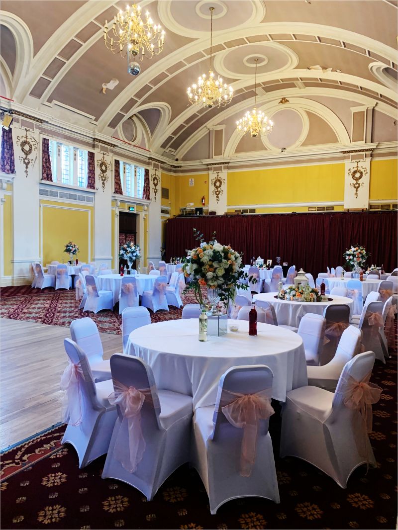 Elegant event space with floral centerpieces, ideal for weddings and gatherings.