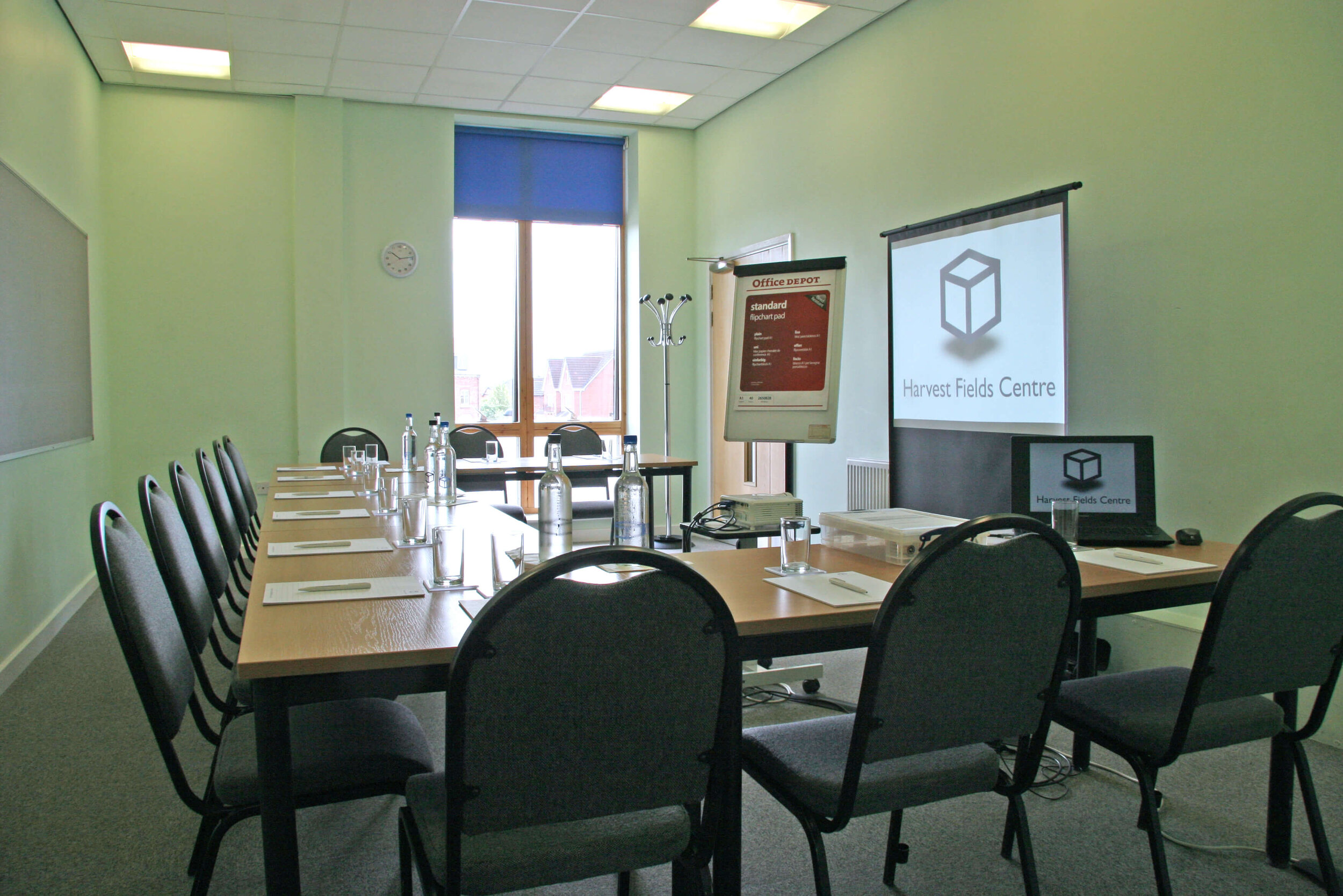 Meeting room with long table and projector, perfect for professional gatherings.