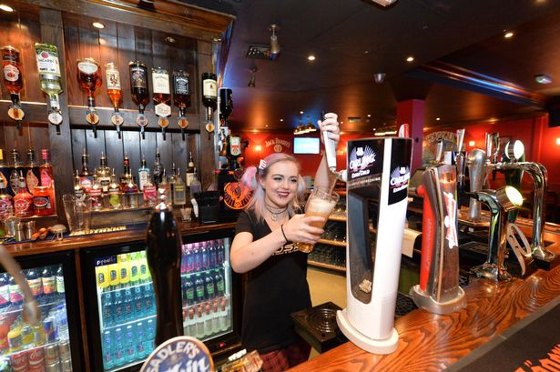 Vibrant Subside Bar scene with bartender pouring drinks for networking events.