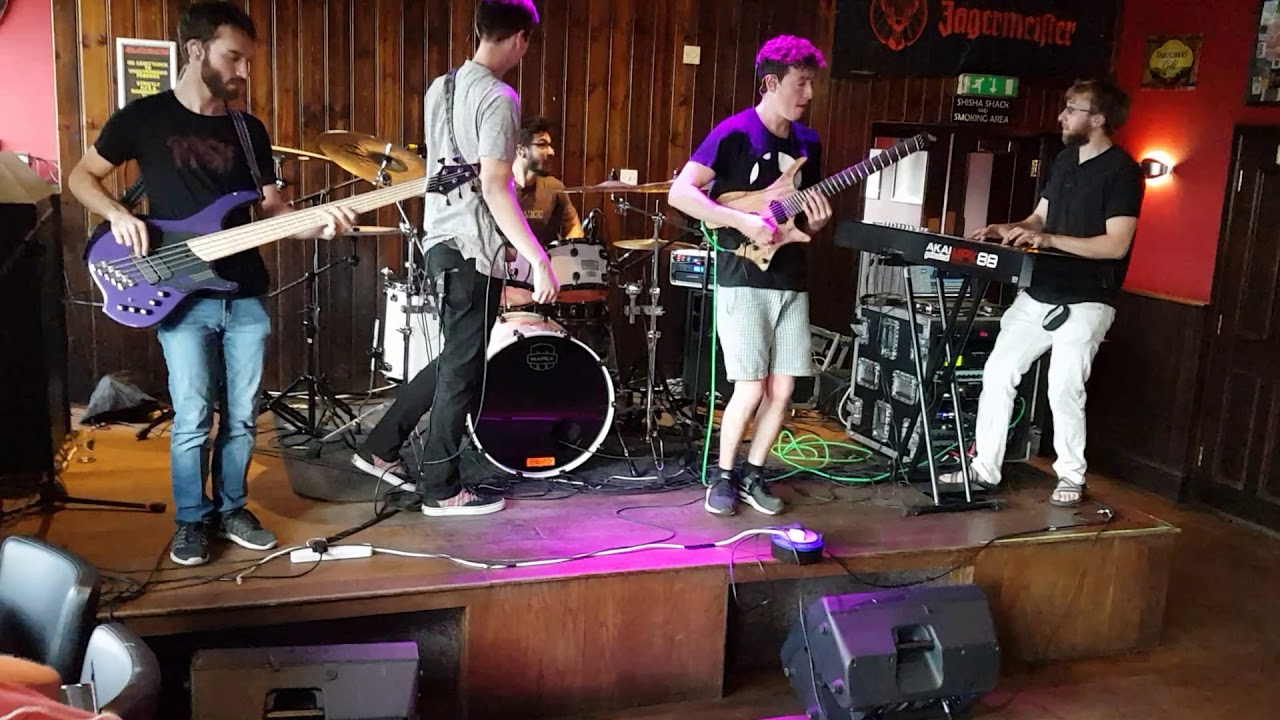 Live band performing at Subside Bar with wooden decor, ideal for events and entertainment.