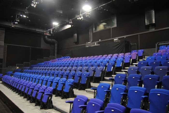 The Crossing Digbeth theater-style seating with vibrant blue and purple chairs for events.