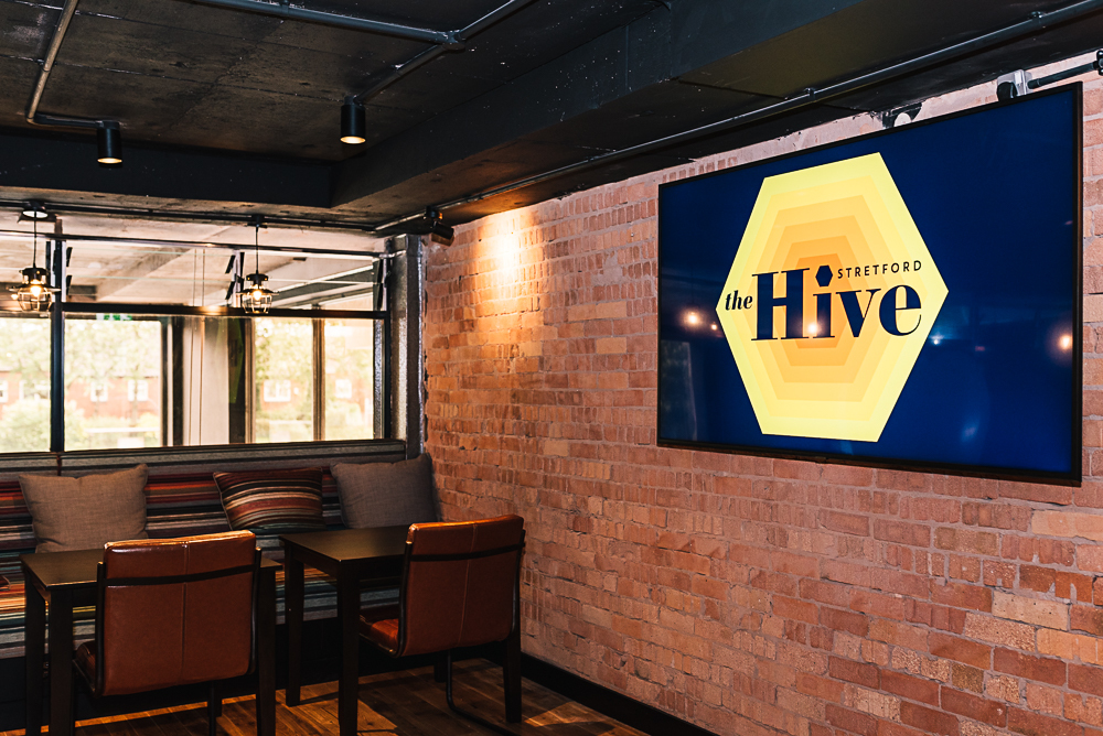 Modern Hive Meeting Room with cozy seating and digital display for workshops and meetings.