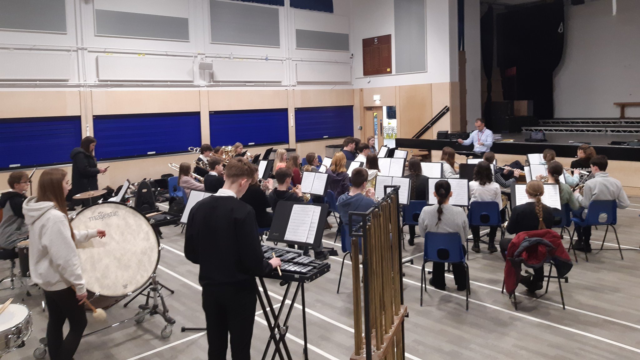 National Concert Band Festival rehearsal with musicians, instruments, collaboration, performance.