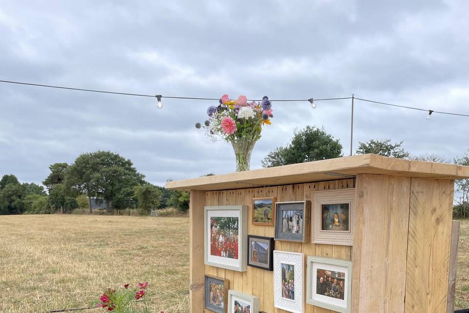 Charming outdoor wedding venue with rustic decor and vibrant flowers at Little Hay.