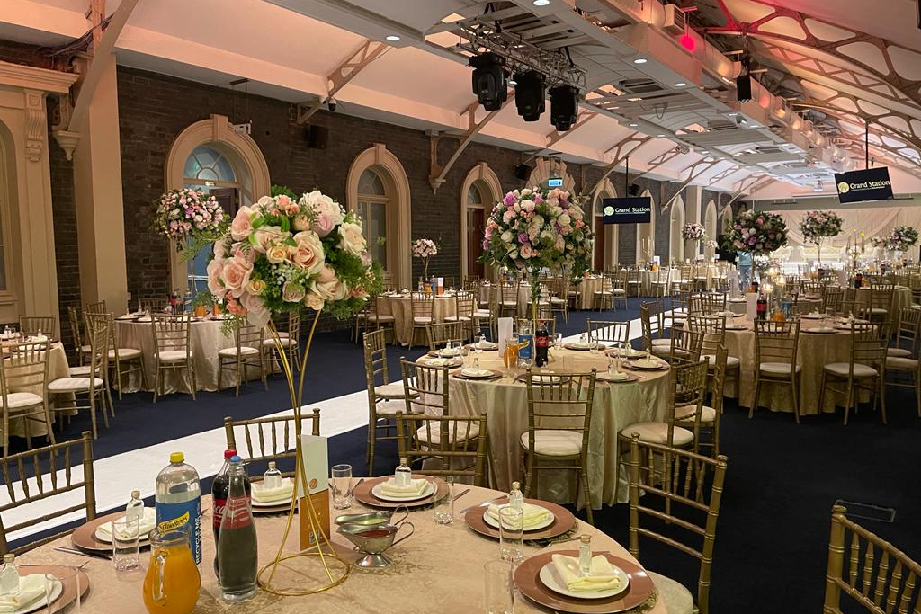 Elegant banquet hall with floral centerpieces for weddings and corporate events.