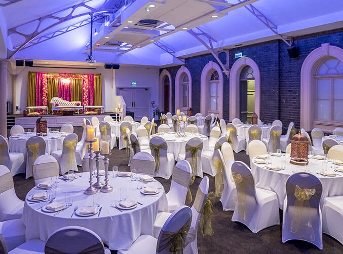 Brunel Suite at Grand Station, elegant wedding venue with white linens and gold accents.