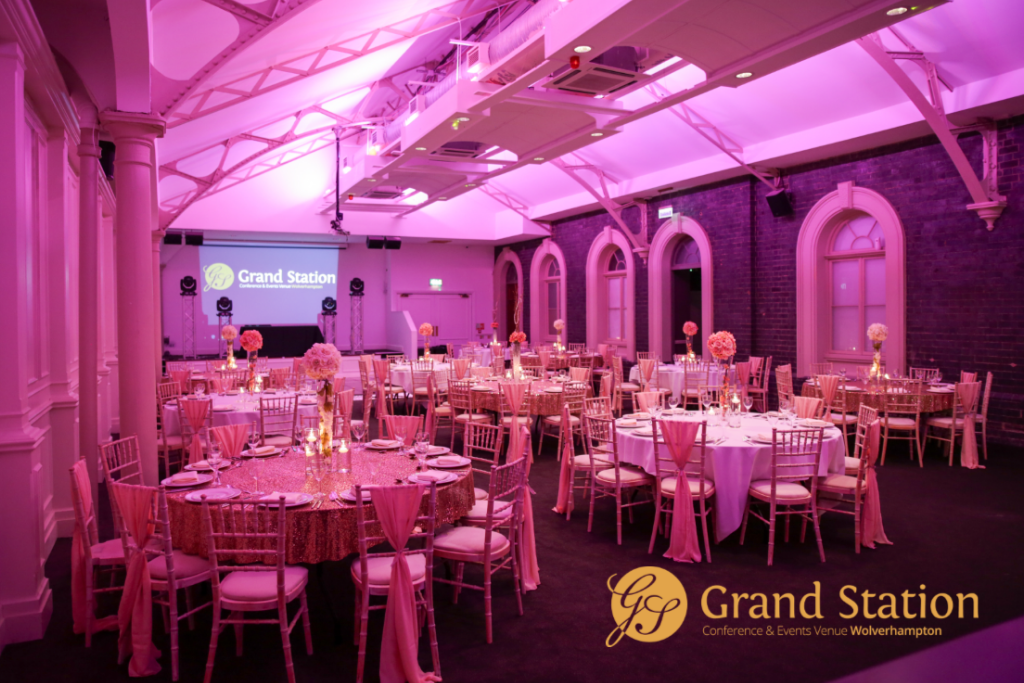 Brunel Suite at Grand Station, elegant event space with pink floral centerpieces.