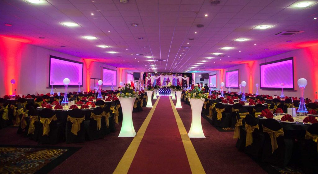 Elegant banquet hall with black and gold decor, ideal for corporate events and galas.