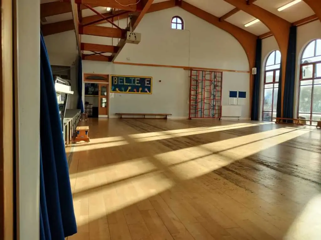 Spacious West Heath Community Centre room with wooden flooring for events and meetings.
