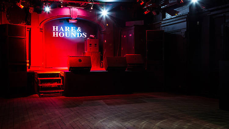 Versatile event space at Hare & Hounds with stage, ideal for live performances and gatherings.