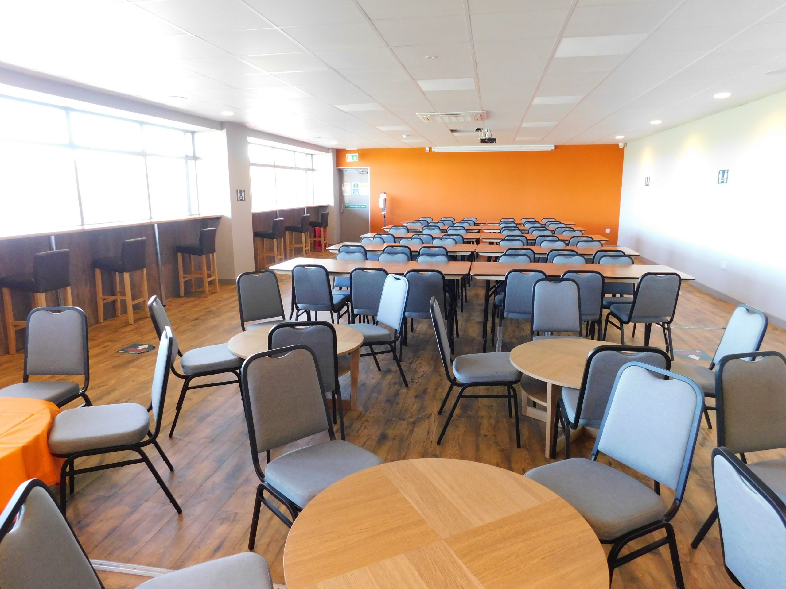 Sports Bar at Castle Vale Stadium, versatile event space with round tables for networking.