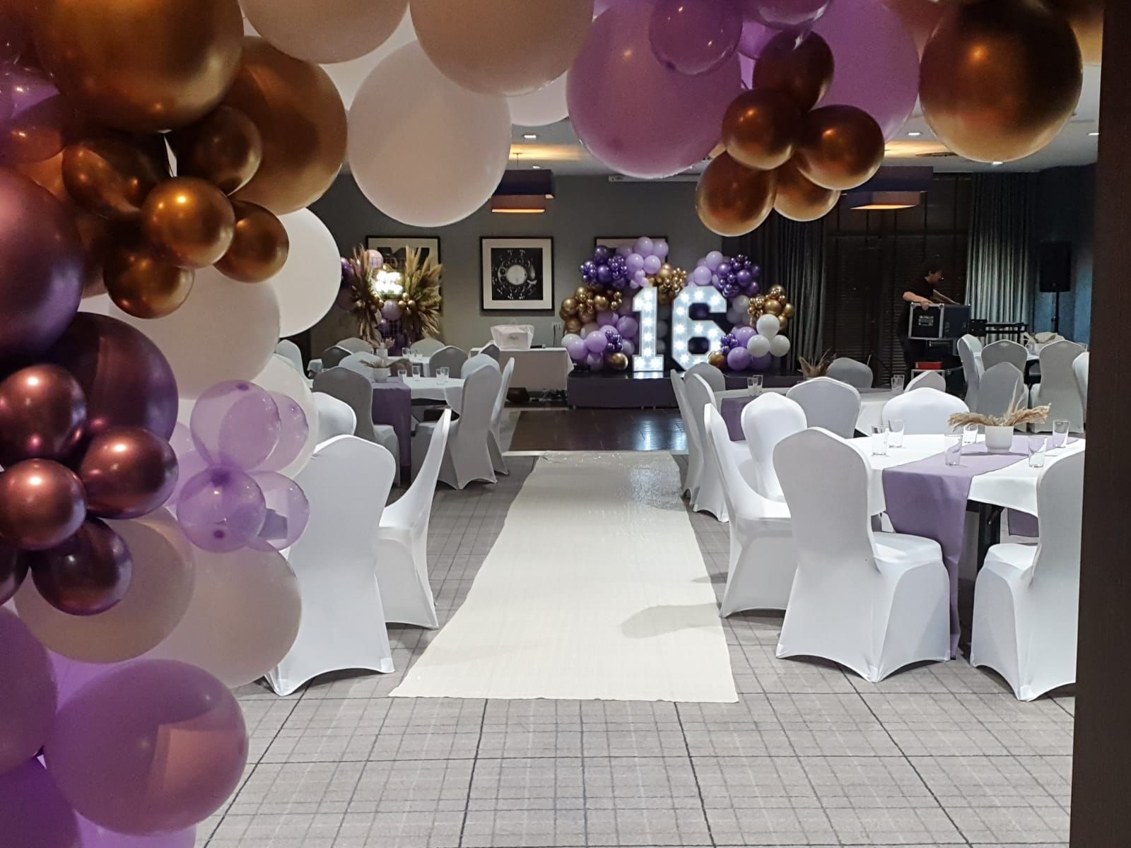 Function room at Village Hotel Solihull with elegant purple and gold decor for sweet sixteen events.