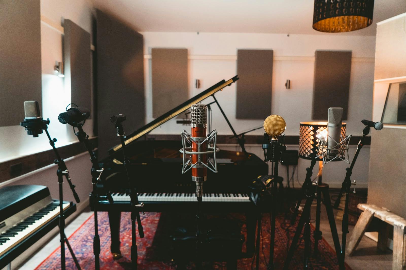 Recording studio with grand piano, ideal for music events and workshops.