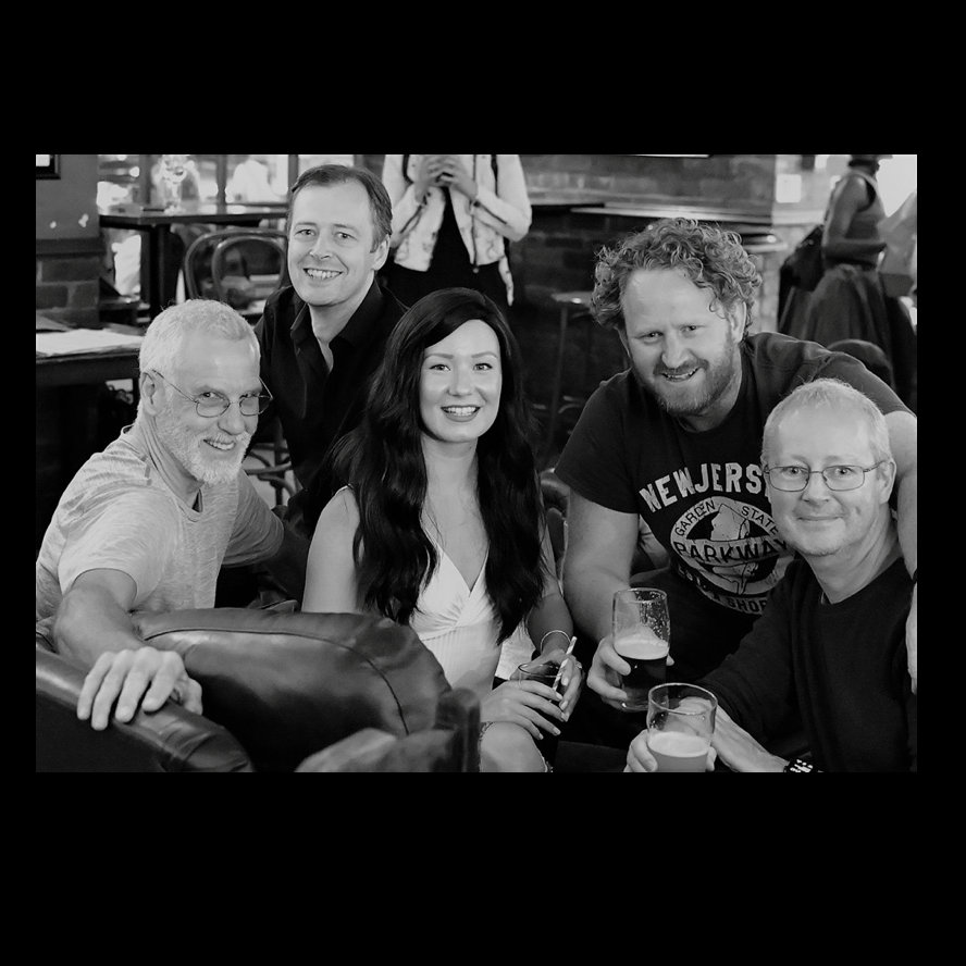 Group of five at a casual networking event, fostering collaboration and engagement.