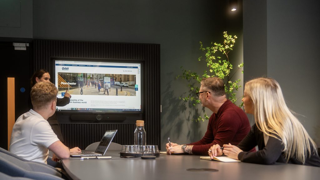 Modern boardroom with digital display for engaging corporate meetings at Orbit Spaces.