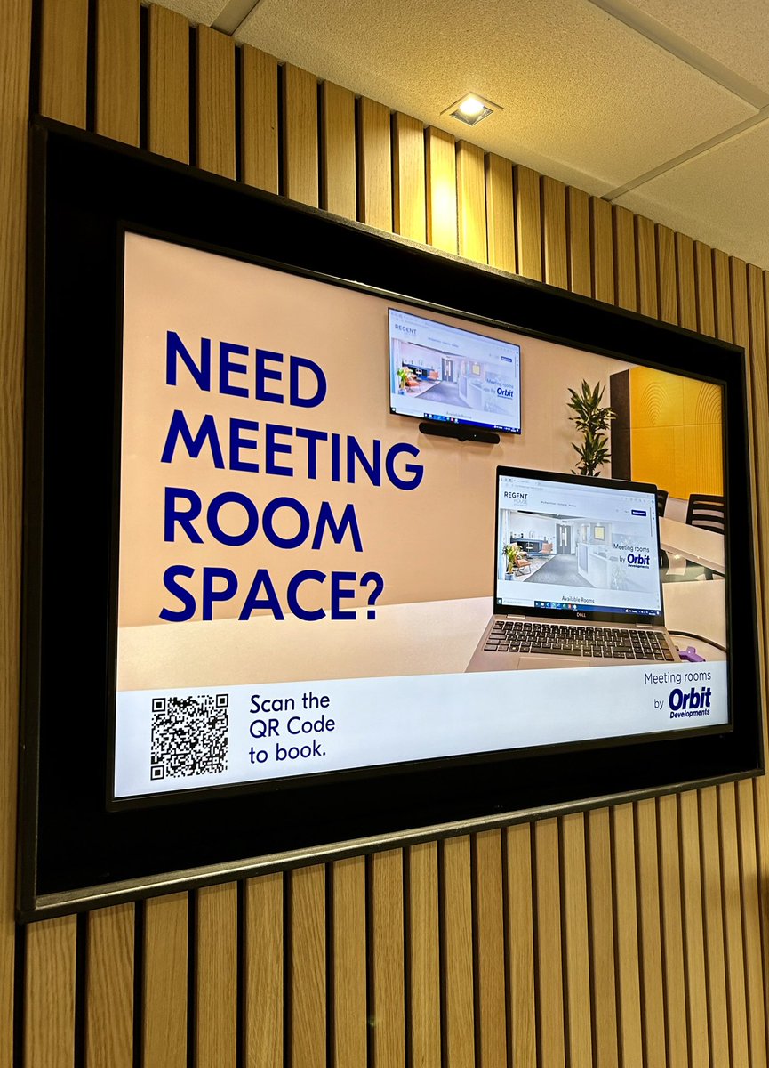 Boardroom in Orbit Spaces with laptop display for easy meeting room bookings.
