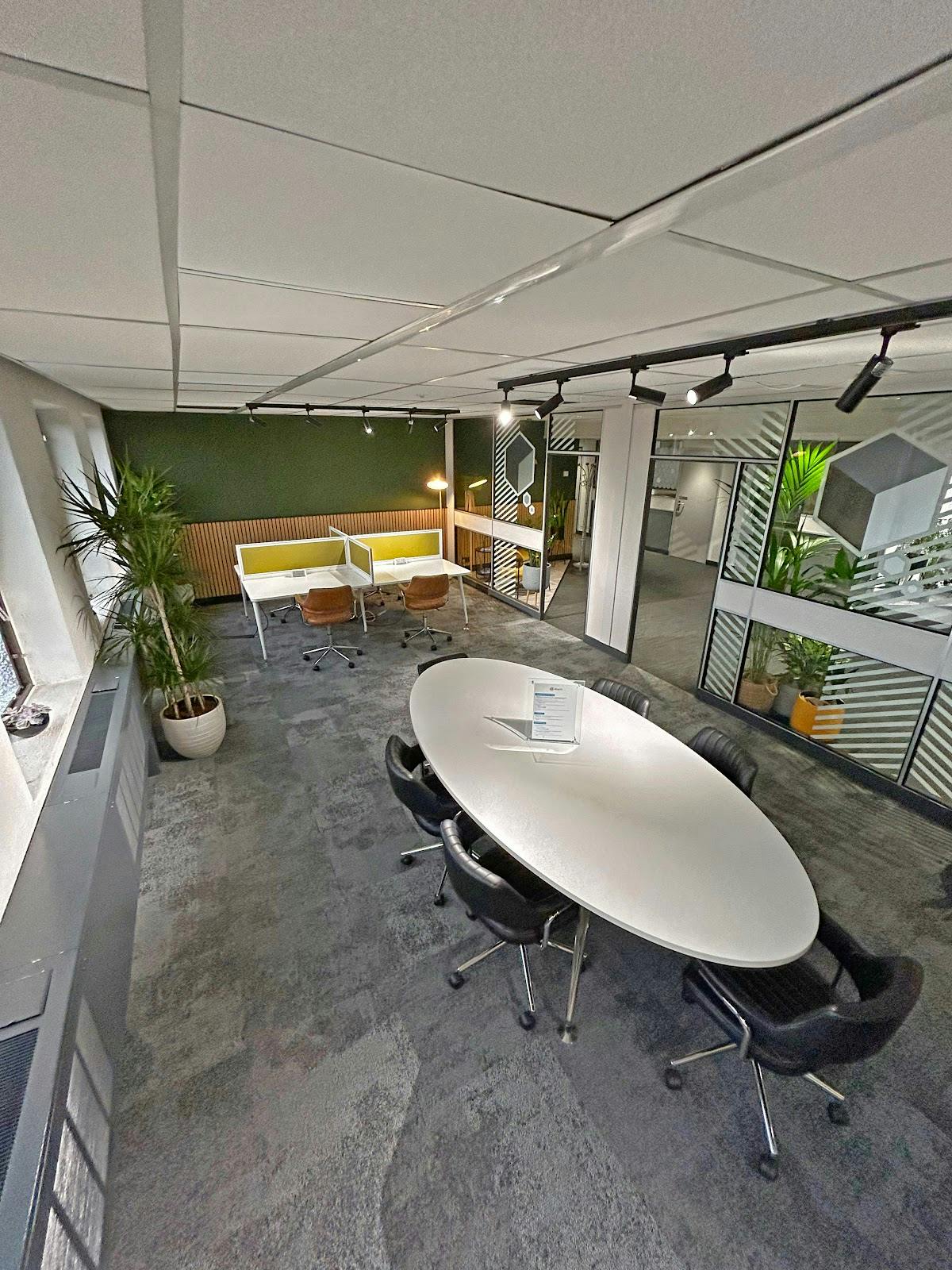 Modern boardroom with round table, ideal for collaborative meetings and events.