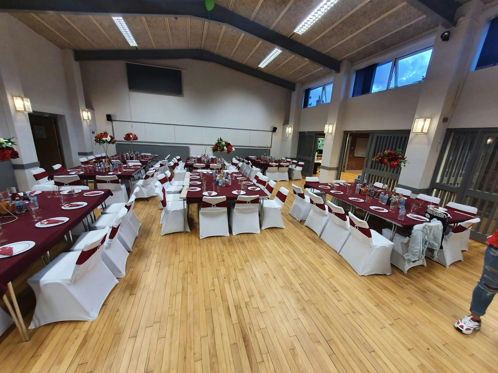 Small hall in Dodford Village Hall, elegant maroon decor for formal networking event.