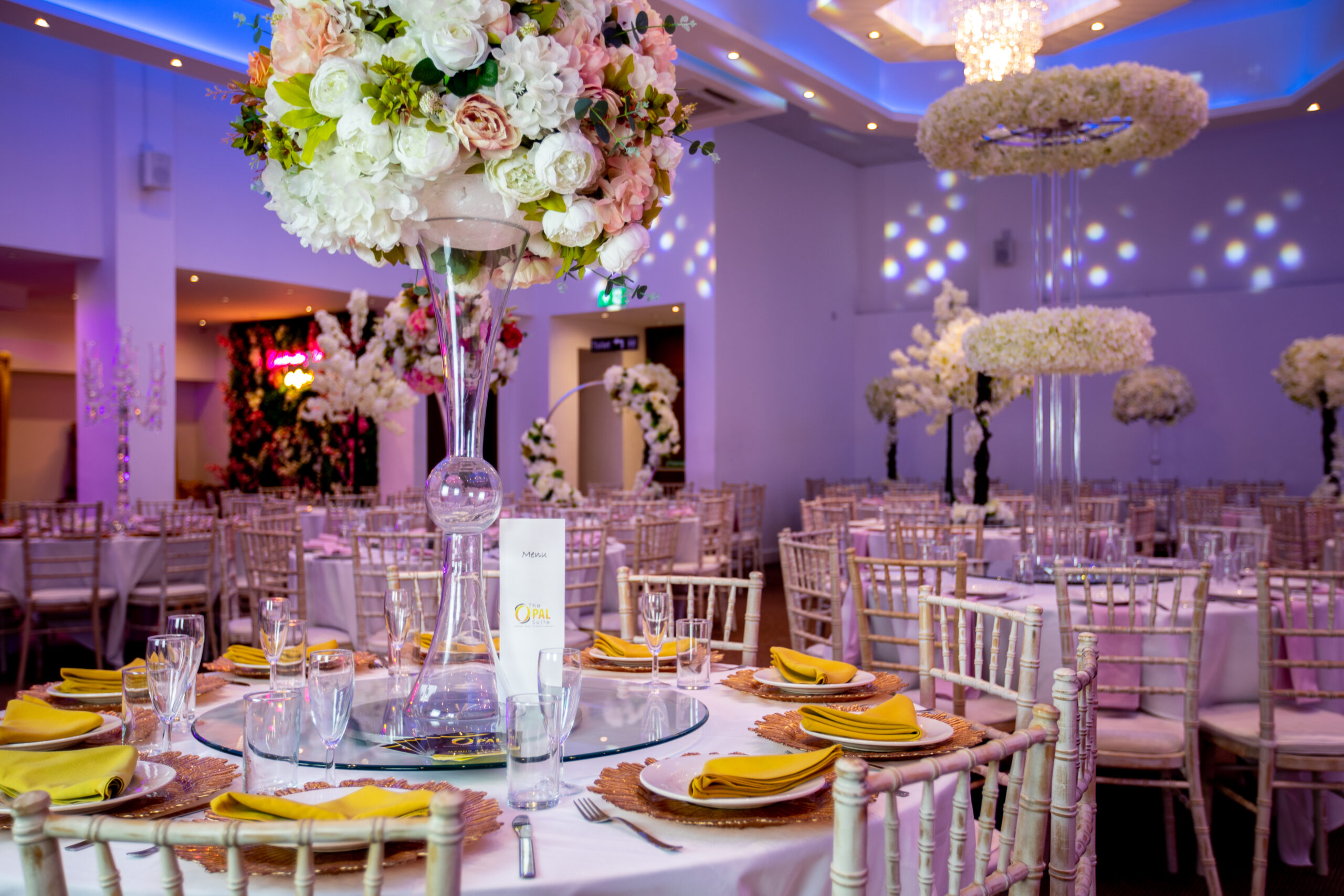 Elegant banquet hall with floral centerpieces for weddings and corporate events.