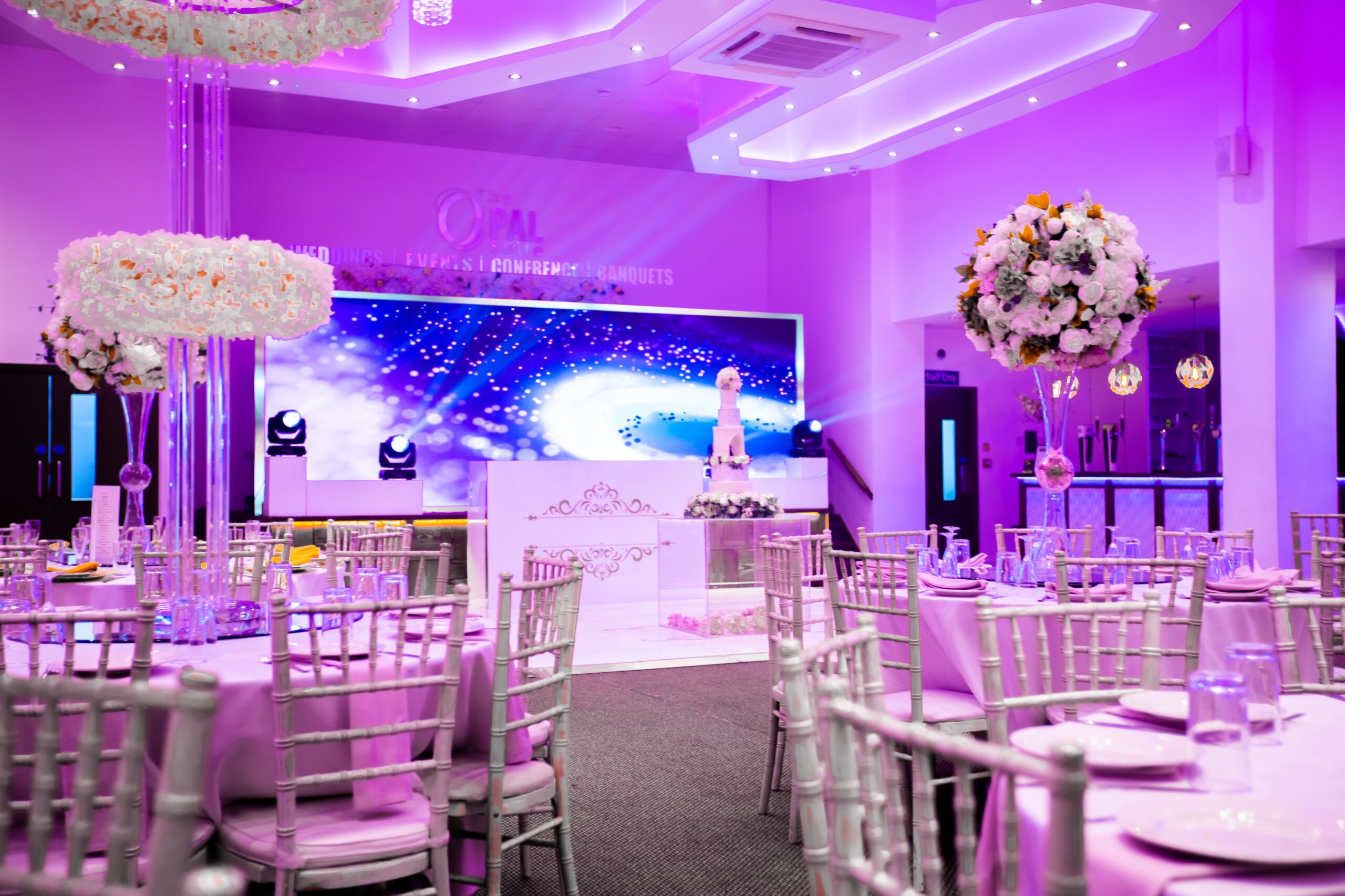 Elegant event space with floral centerpieces, perfect for weddings and upscale gatherings.
