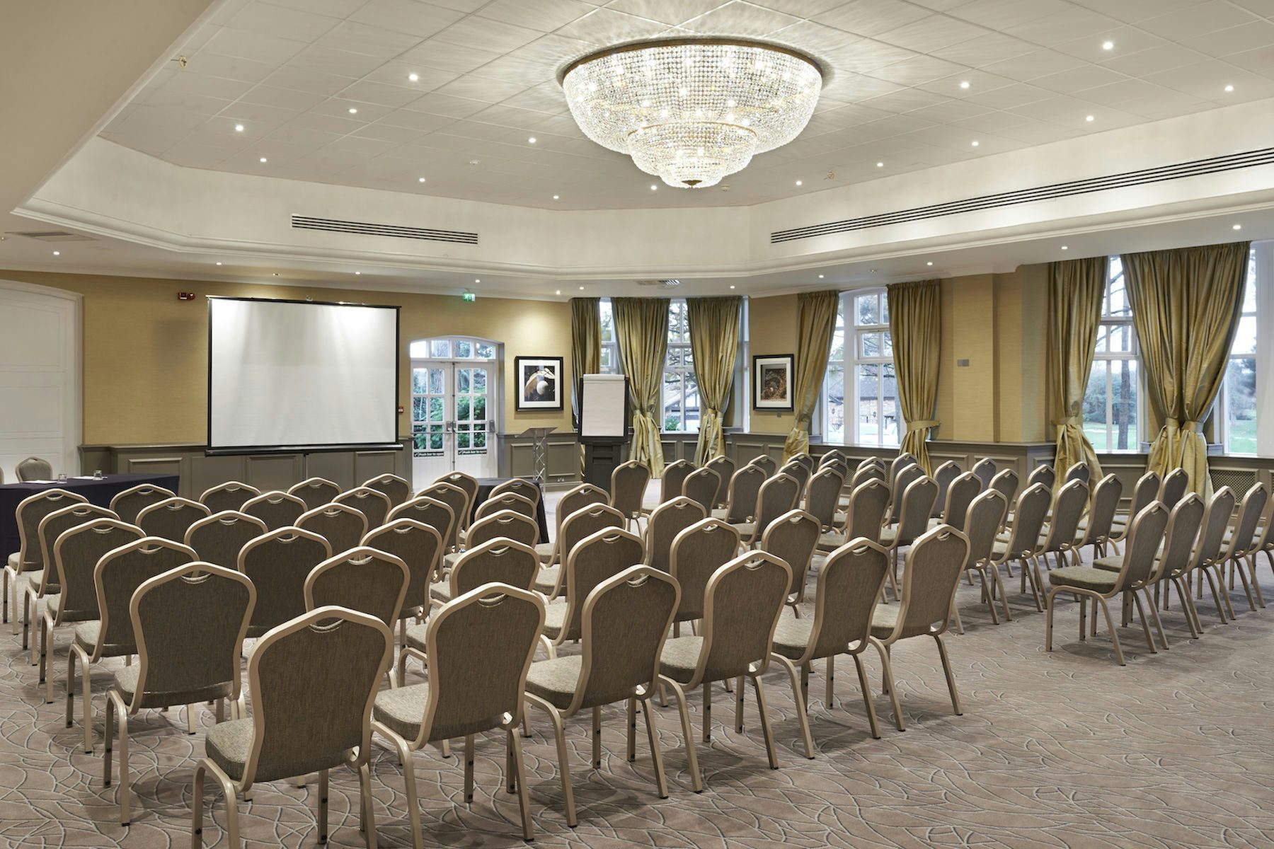Elegant conference room with chandelier, perfect for seminars and meetings.