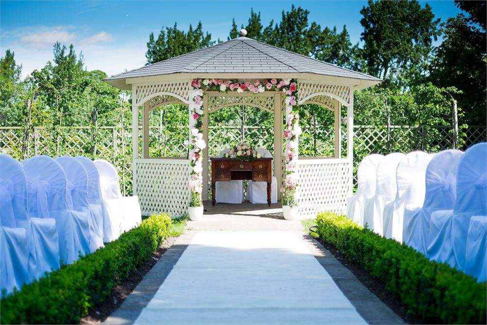 Outdoor wedding gazebo with floral decor at Warwick House, ideal for romantic ceremonies.