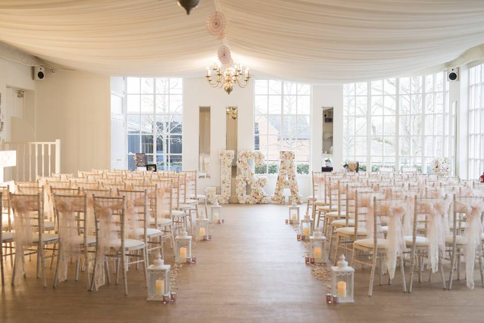 Ornate function room with chiavari chairs, ideal for weddings and formal events.