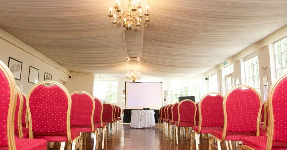 Ornate Function Rooms with red chairs, ideal for conferences and seminars.