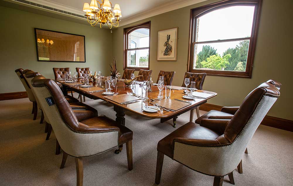 De Port Private Dining Room with elegant wooden table, perfect for corporate retreats.