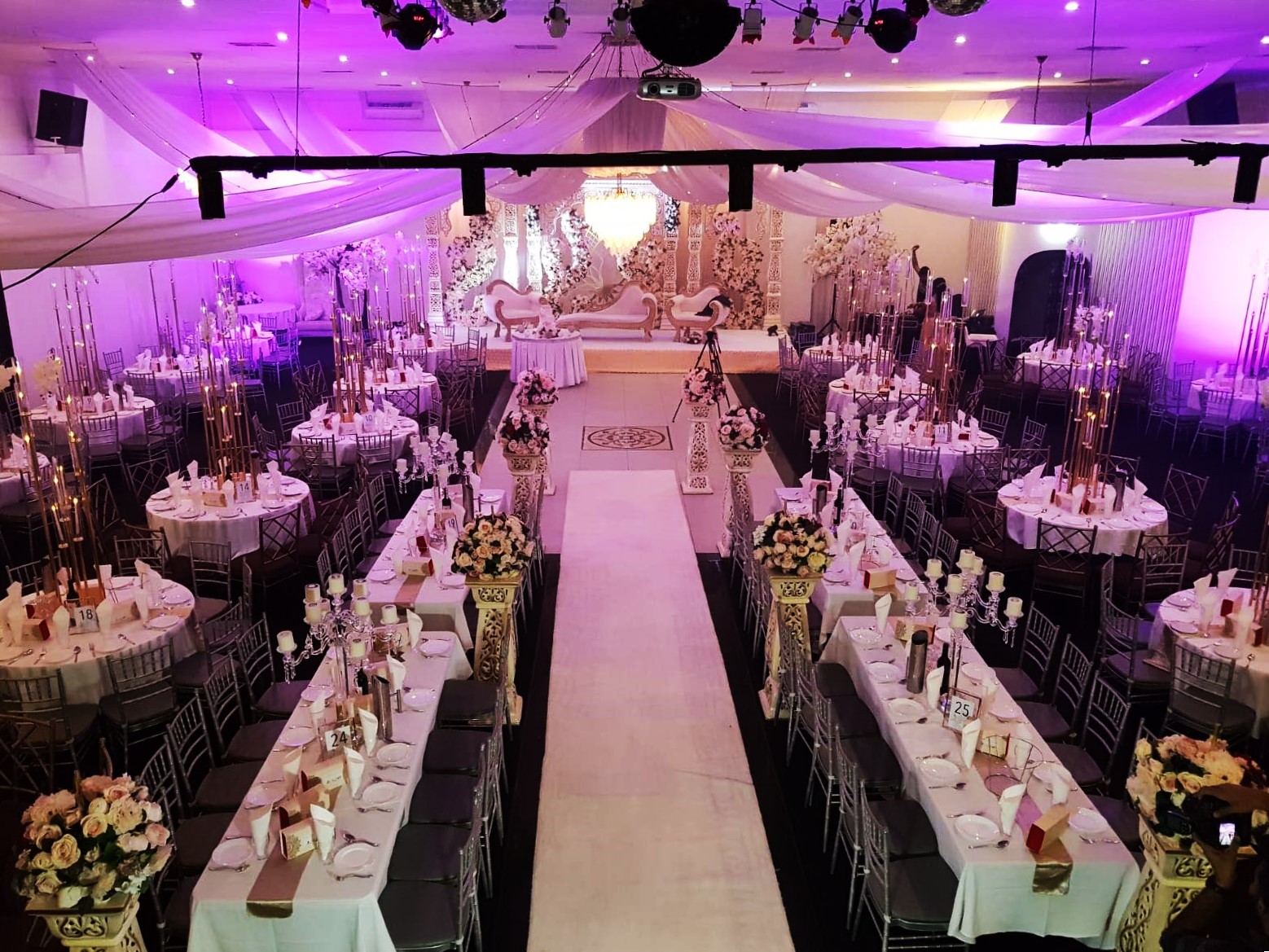 Elegant event space with floral centerpieces, perfect for weddings and galas.