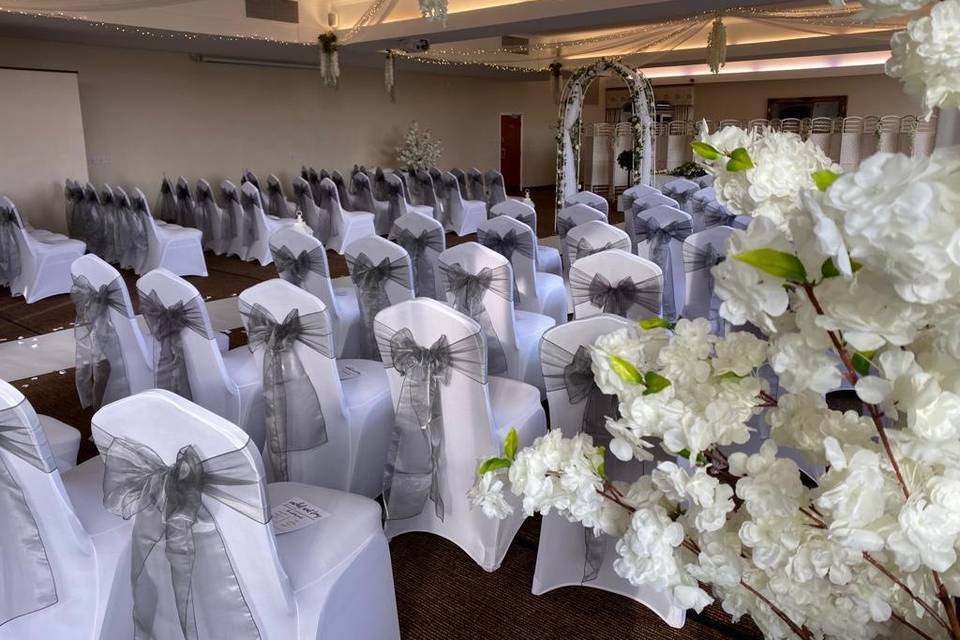 Elegant dining room at Weatheroak Hall with gray-sashed chairs for weddings and events.