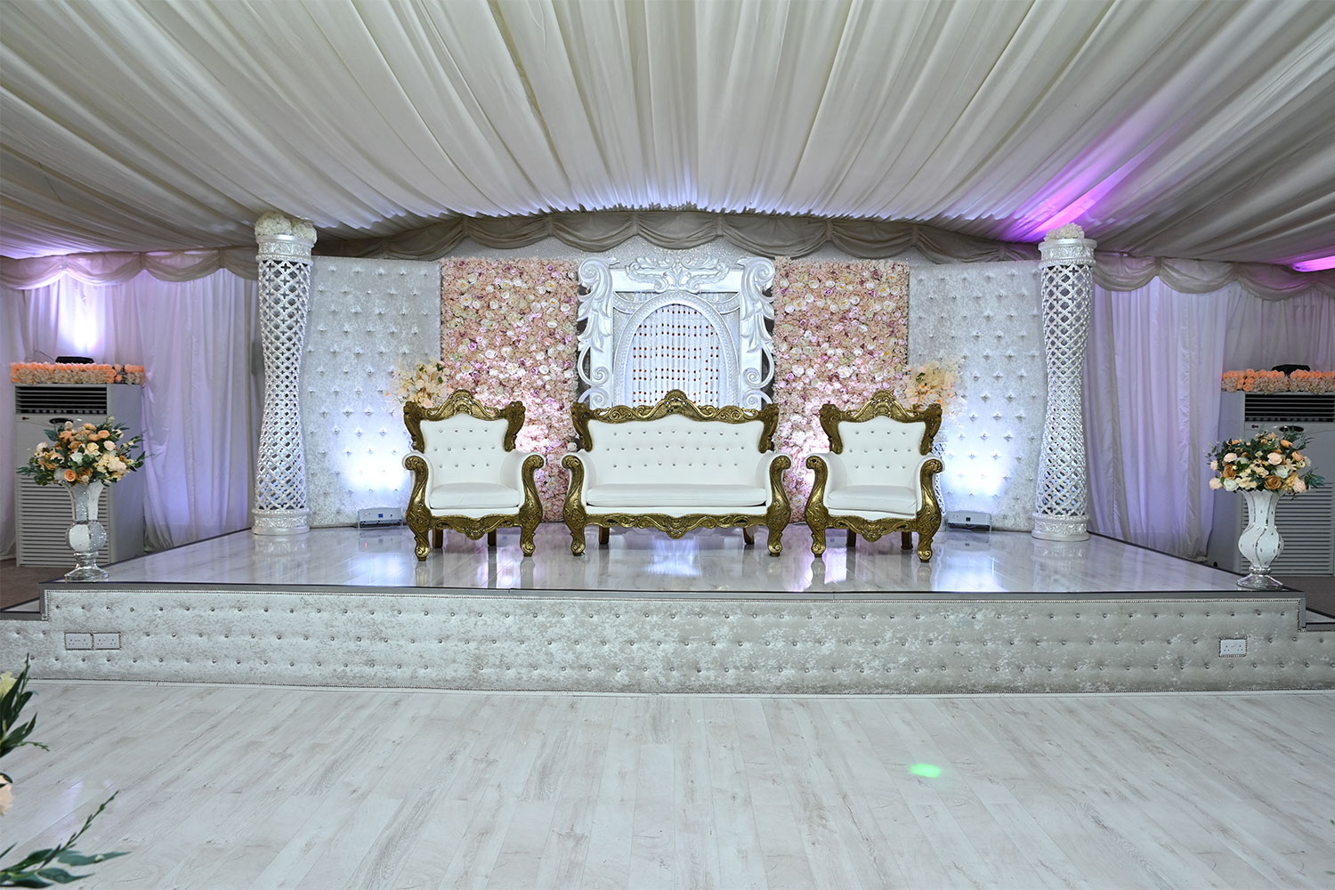 Elegant event stage with floral backdrop in Digbeth Hall, perfect for weddings and ceremonies.