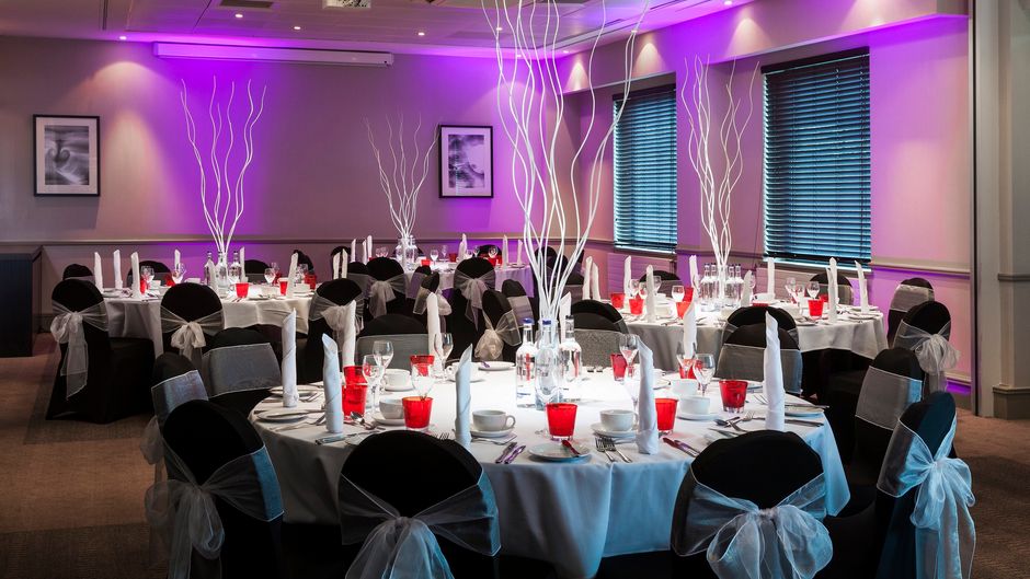Oasis Suite banquet room with elegant tables, ideal for weddings and corporate events.