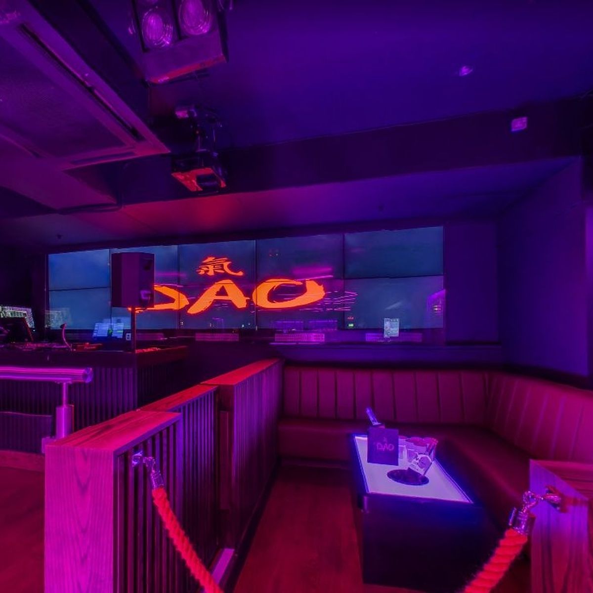 Vibrant event space in Rosies Birmingham with illuminated "DAO" backdrop for networking events.