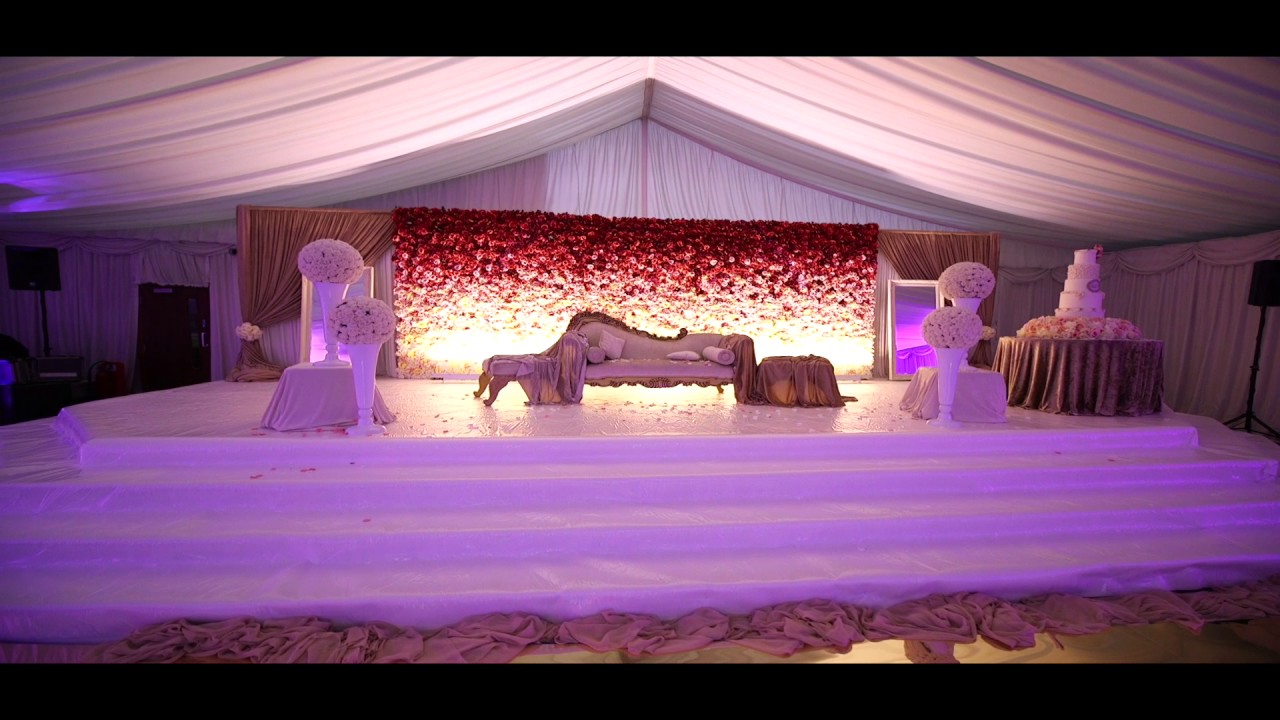 Elegant Banqueting Hall with floral backdrop, ideal for weddings and upscale events.