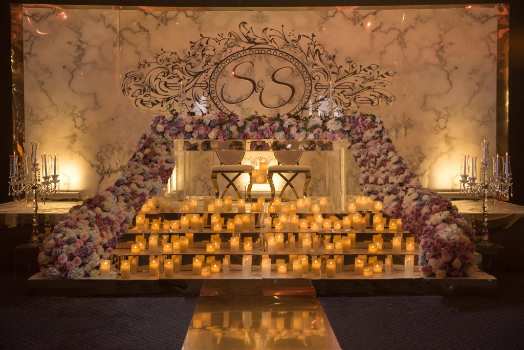 Elegant banquet setup in Prestige Suite with floral backdrop, perfect for weddings.