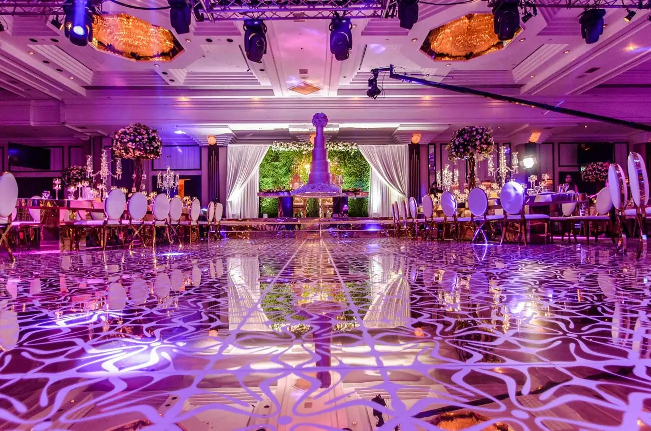Elegant Grand Ballroom with floral centerpieces, perfect for upscale weddings and events.