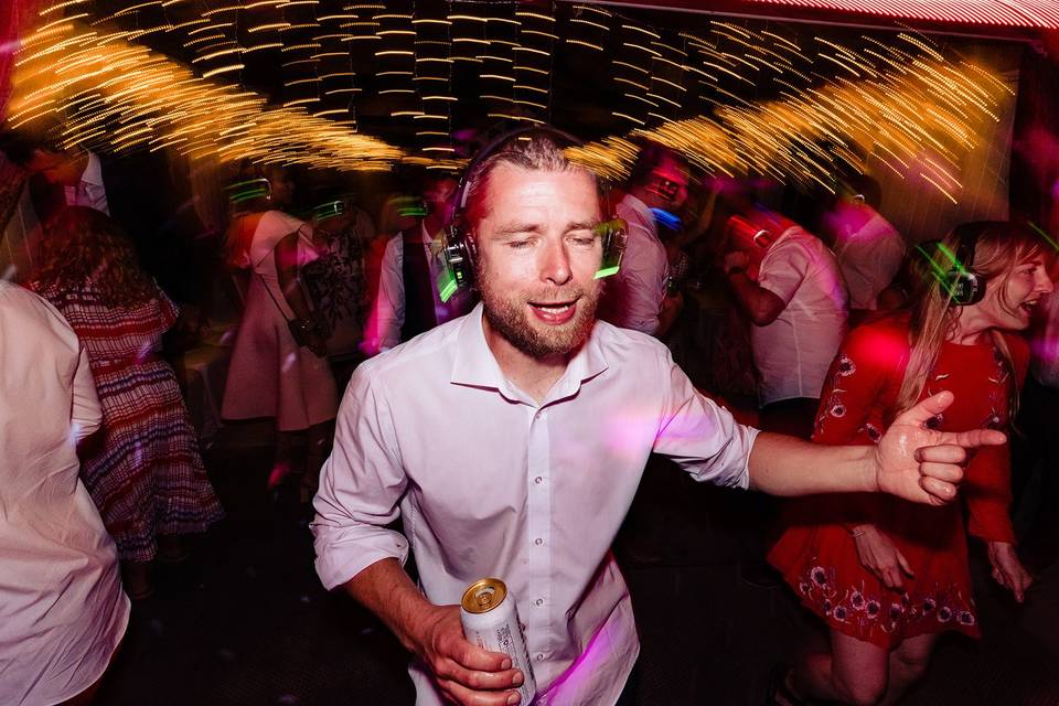 "Silent disco photo booth with colorful lights at a vibrant event celebration."