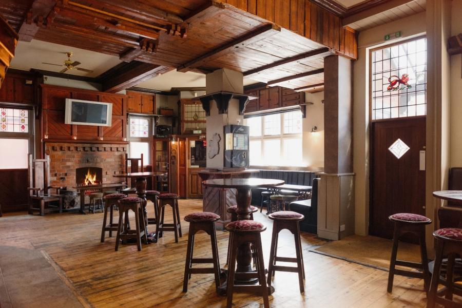 Cozy rustic bar with wooden decor, ideal for networking events and team-building activities.